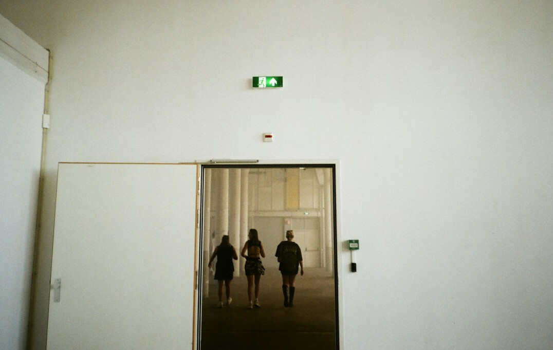 Diverse group of Belgian professionals walking in an office hallway